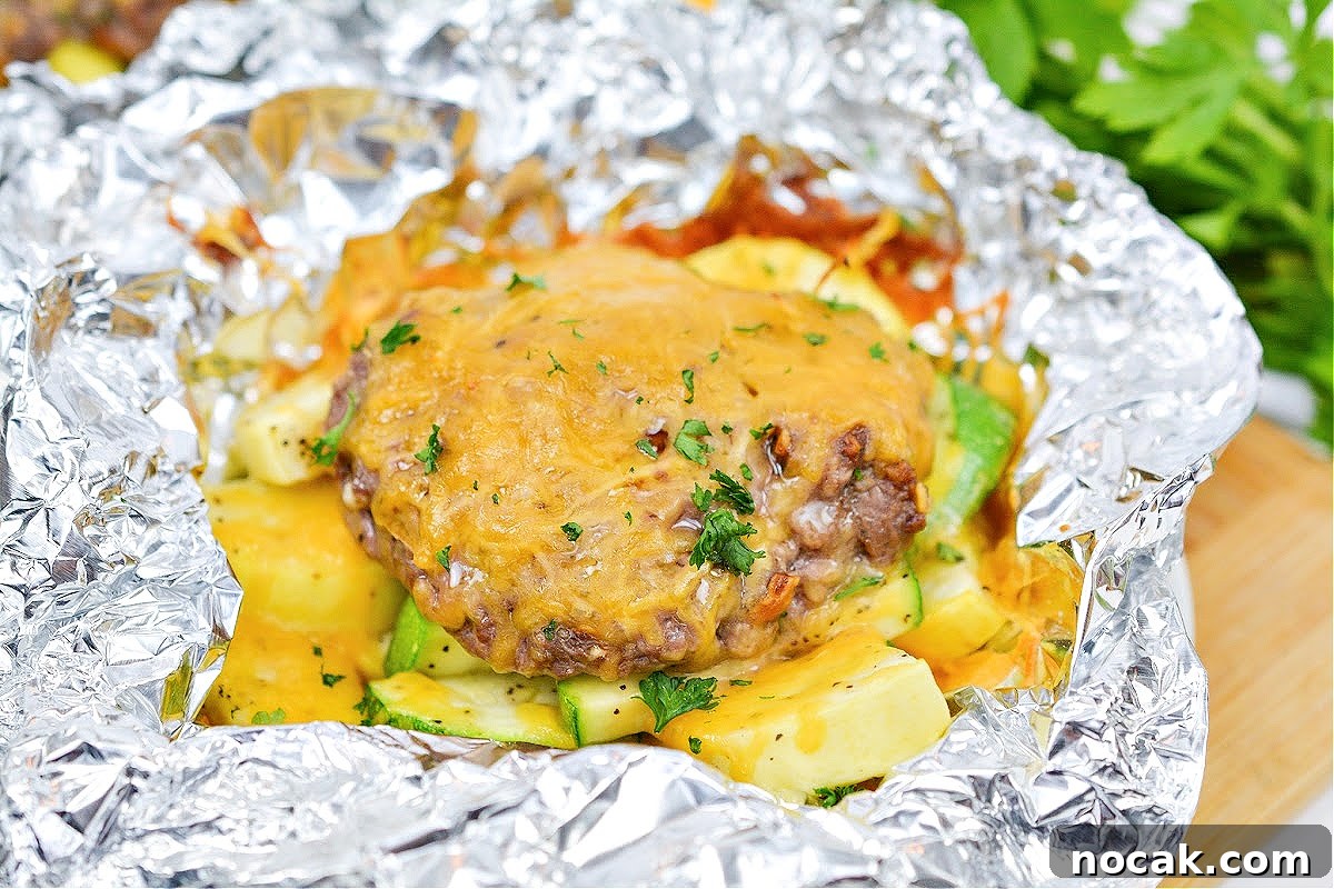 Keto Cheeseburger Foil Packets for Air Fryer Cooking 5 A keto cheeseburger in a foil packet with zucchini and yellow squash