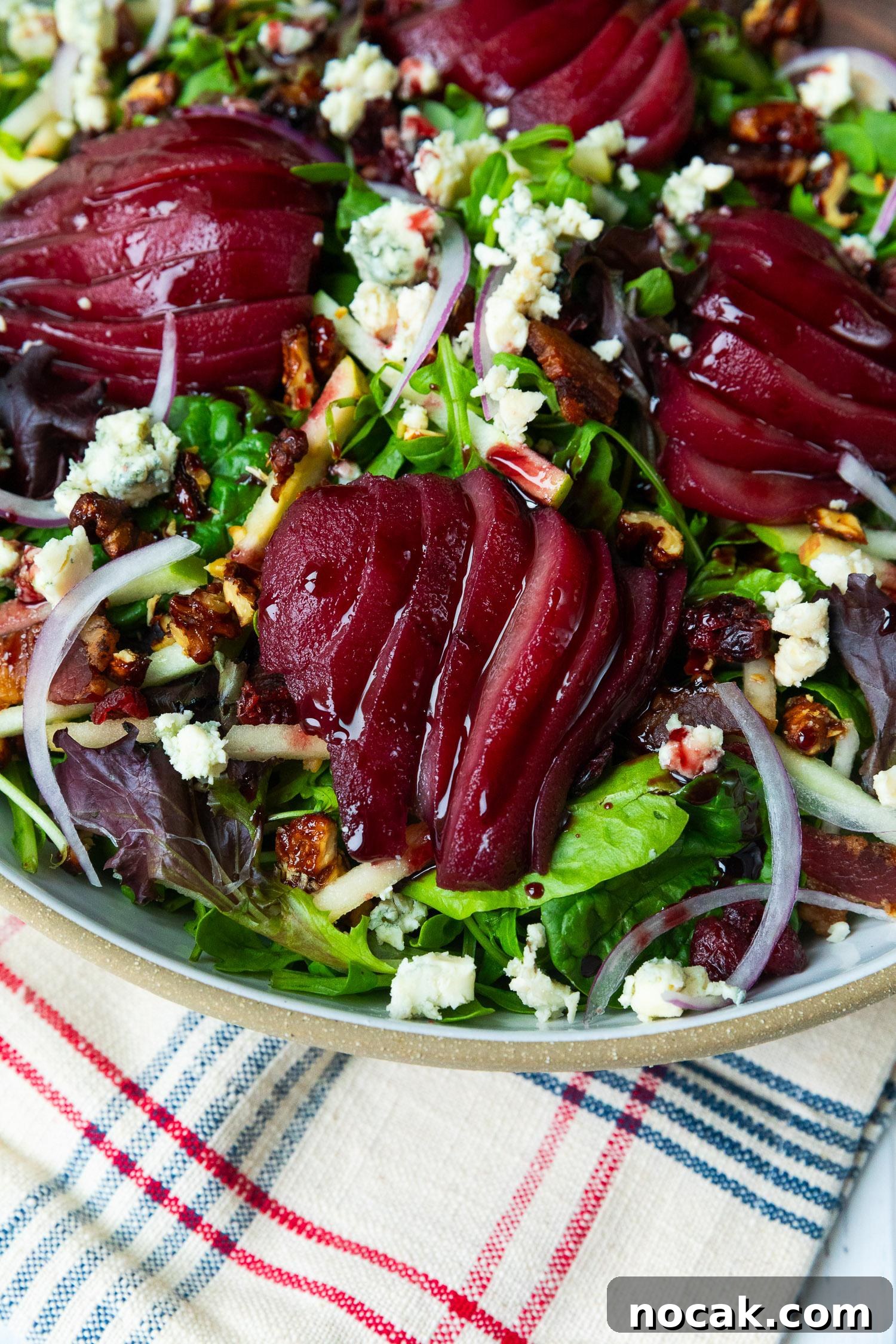 Red Wine-Poached Pear Salad with Blue Cheese, Pancetta & Walnuts 6 Sliced poached pears on salad