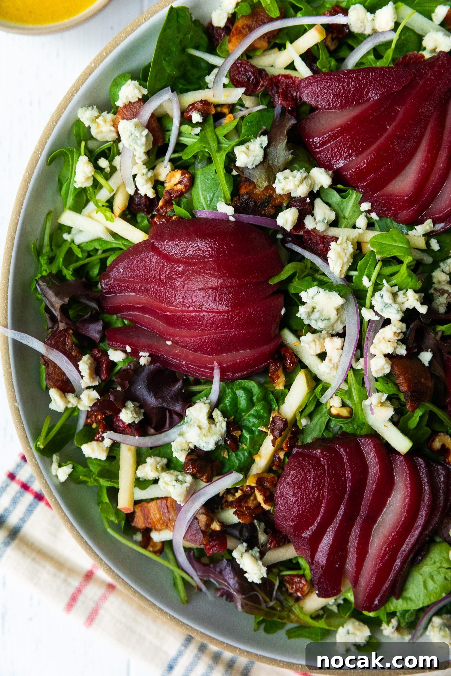 Red Wine-Poached Pear Salad with Blue Cheese, Pancetta & Walnuts 7 Walnuts and cranberries topping salad