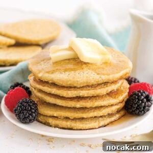 Fluffy Oat Flour Pancakes Recipe for Light, Tender Stacks 9 Serving up pancakes with oat flour in a stack with berries.