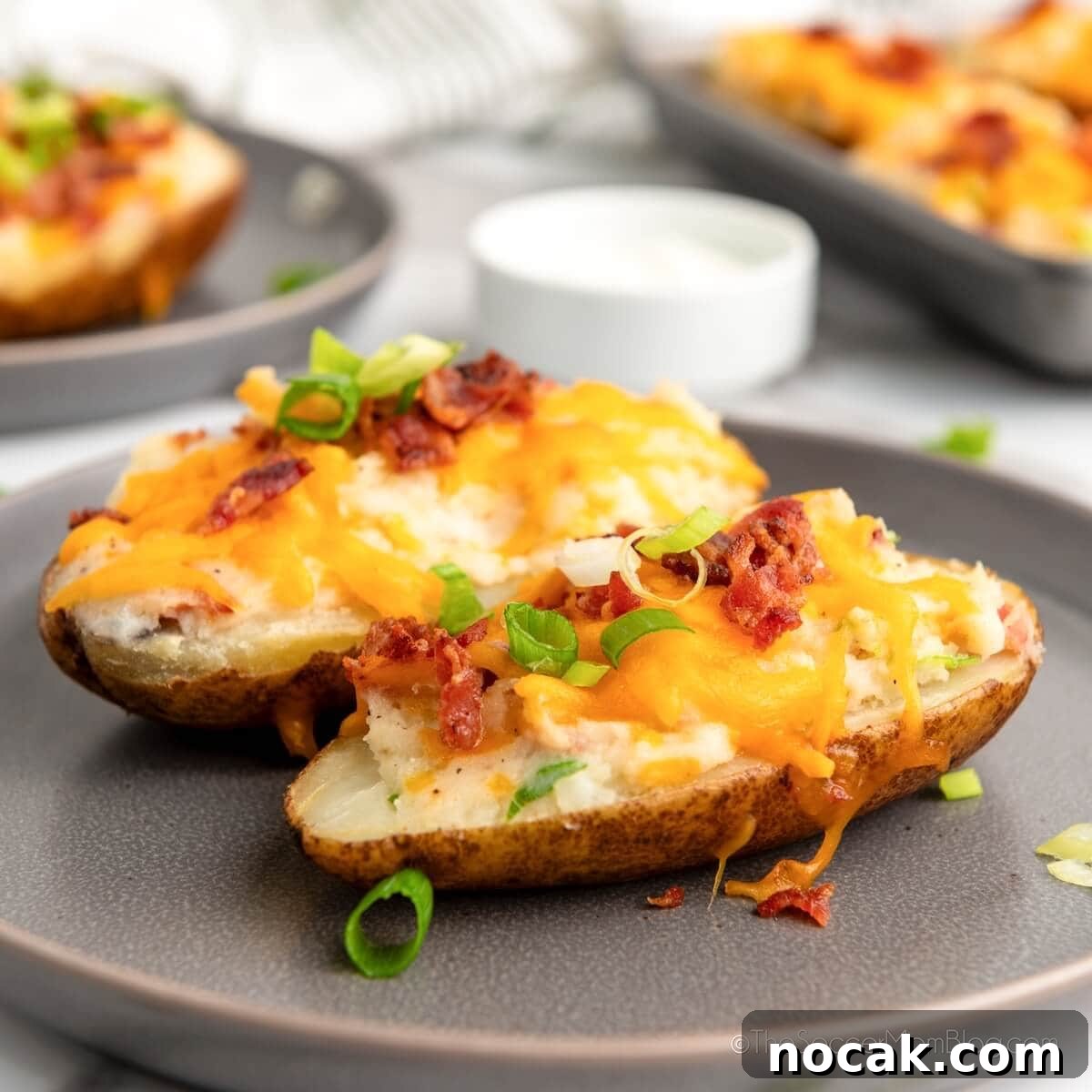 Ultimate Twice-Baked Potatoes Recipe for Crispy, Creamy Filling 7 Twice Baked Potatoes on a serving plate.