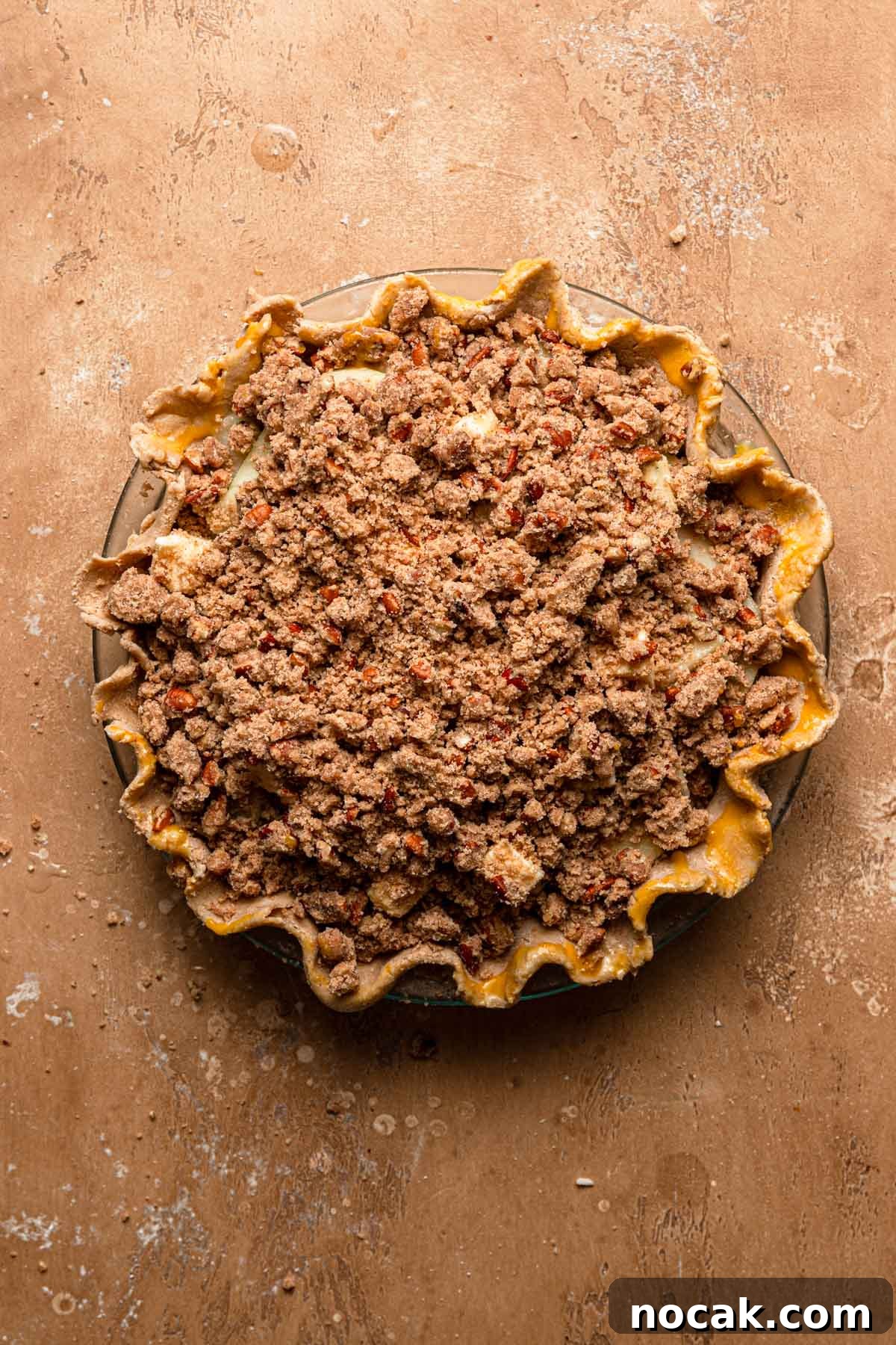 Pie topped with streusel ready for oven.