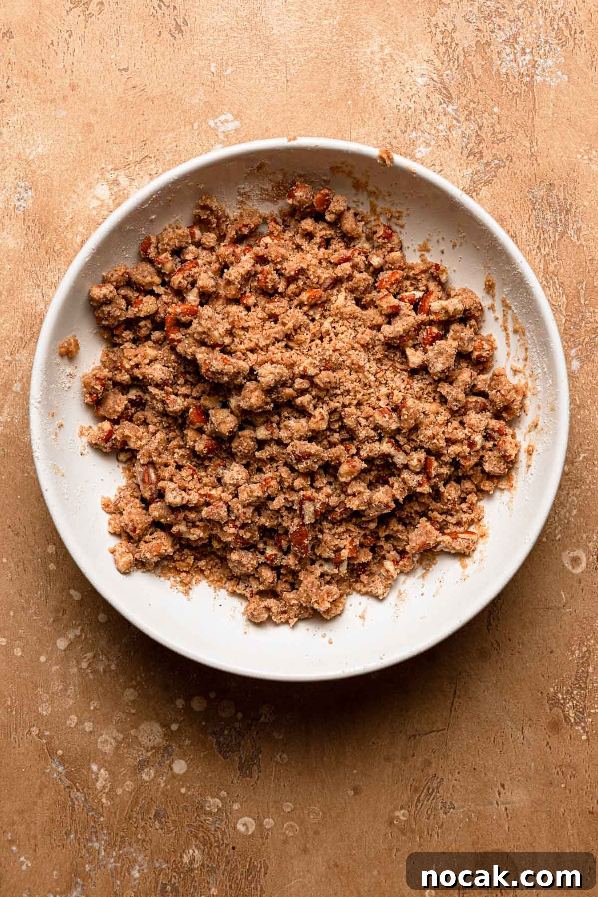 A bowl with pecan cinnamon streusel.