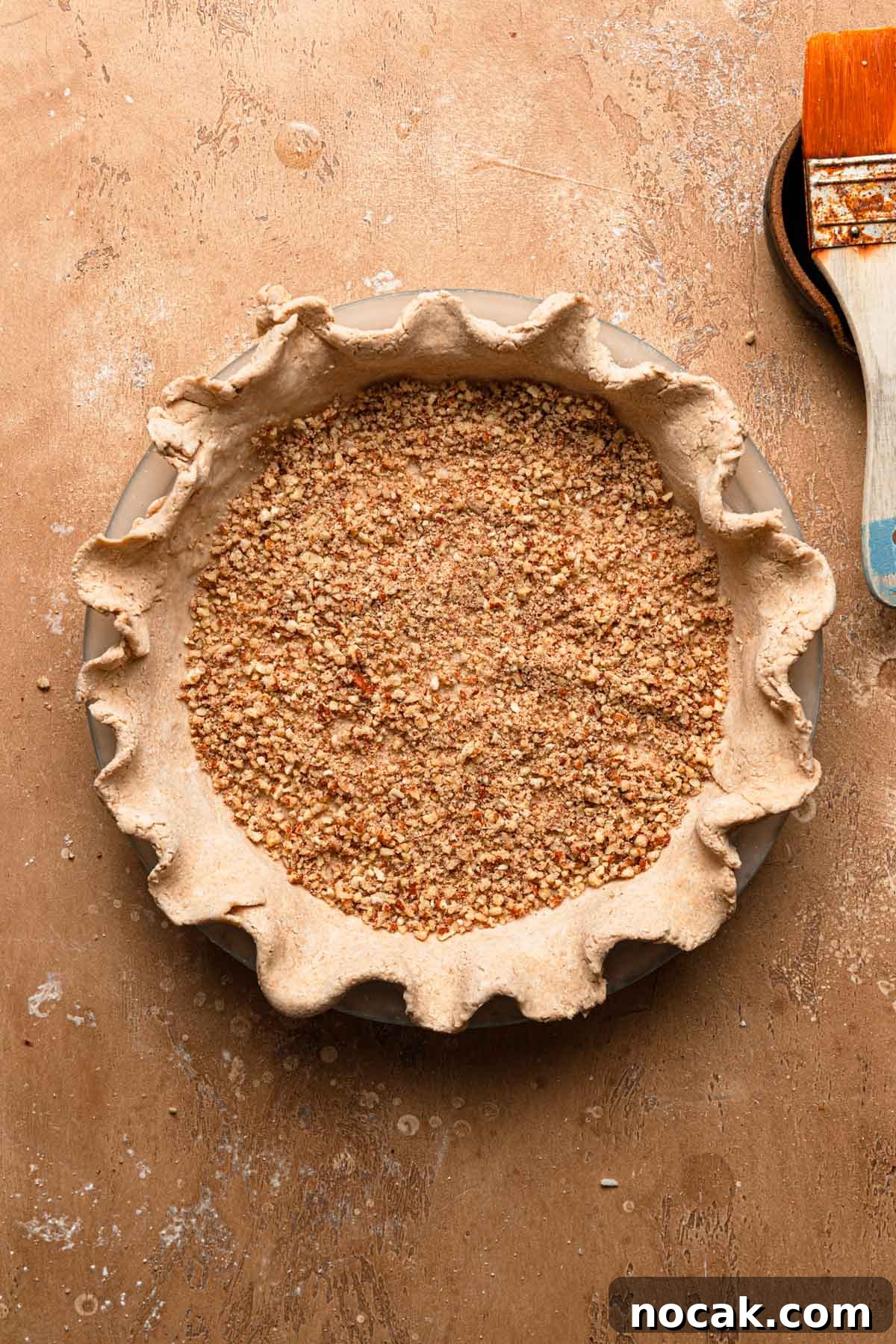 Crust brushed with egg white and sprinkled with ground pecans.