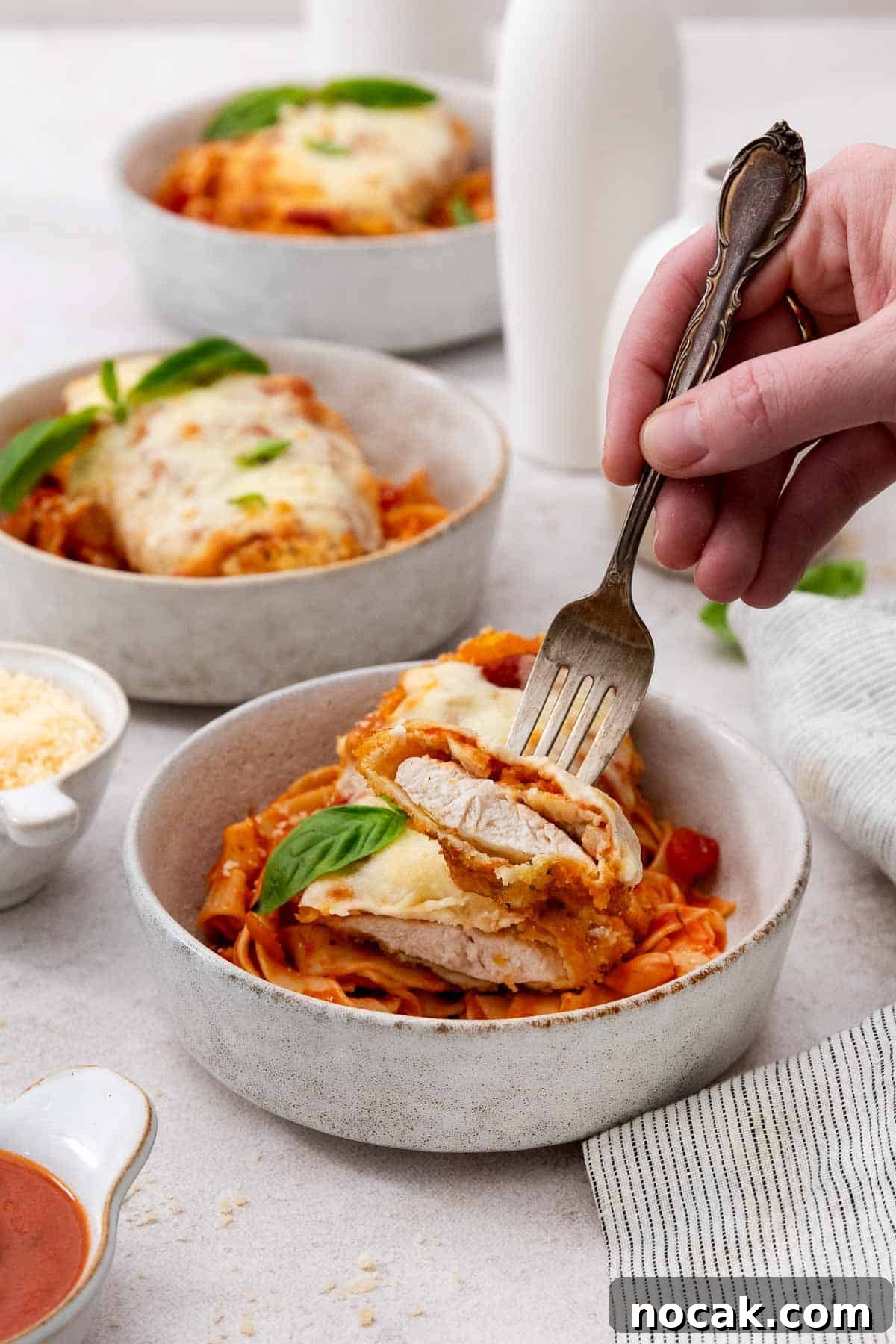 Crispy Gluten-Free Chicken Parmesan Recipe for Dinner 7 Serving chicken parmesan with a fork
