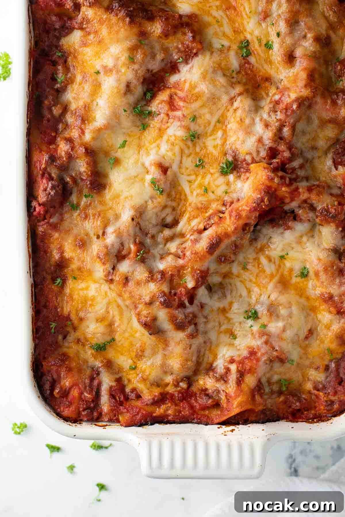 Crispy Gluten-Free Chicken Parmesan Recipe for Dinner 8 close up overhead shot of gluten free lasagna in white baking dish