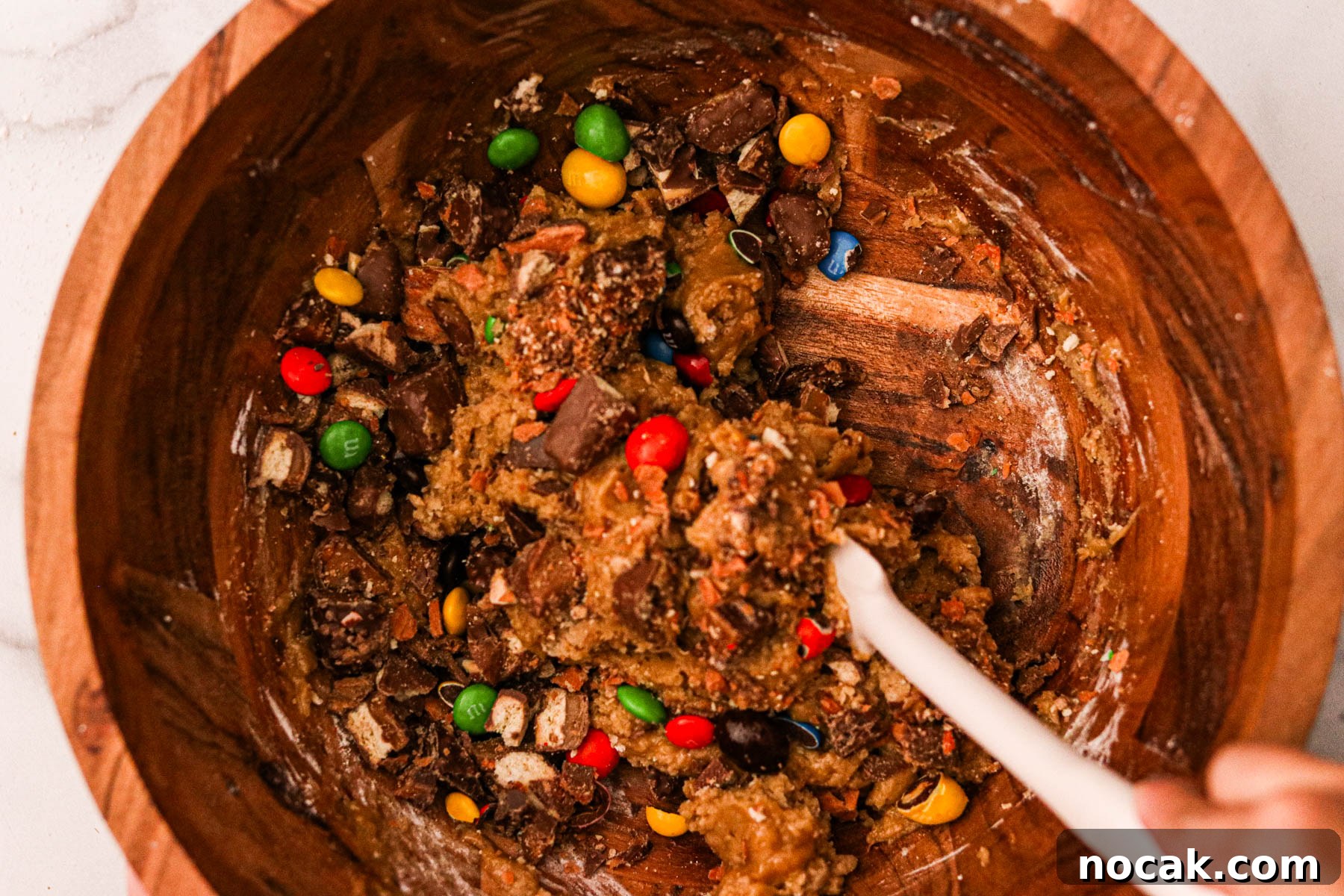 Leftover Halloween Candy Cookie Bars Recipe for Using Candy Up 7 Ingredients for the shortbread layer being mixed in a large bowl, forming a dough.
