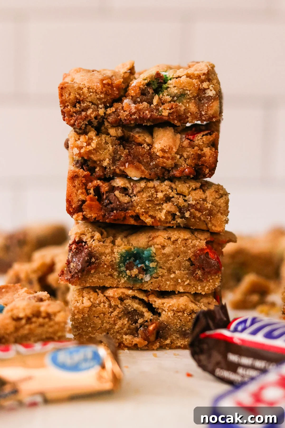 Leftover Halloween Candy Cookie Bars Recipe for Using Candy Up 10 Close-up of leftover Halloween candy cookie bars sliced into squares and stacked on top of one another.