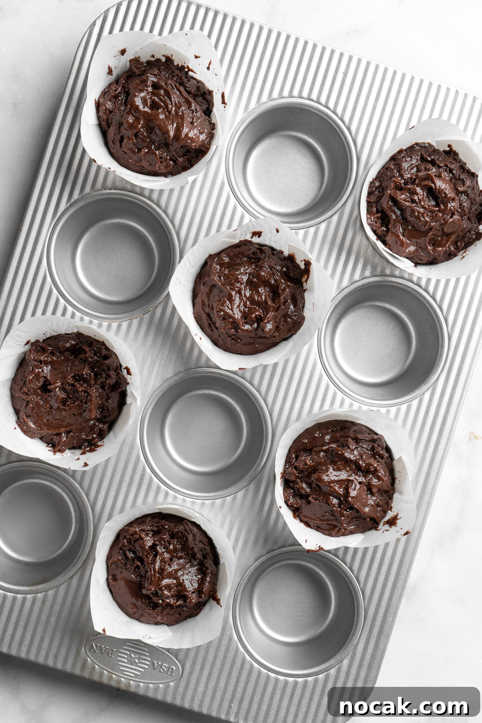 Bakery-Style Double Chocolate Chip Muffins with SunButter Swirl 4 Bakery style double chocolate chip muffin batter.