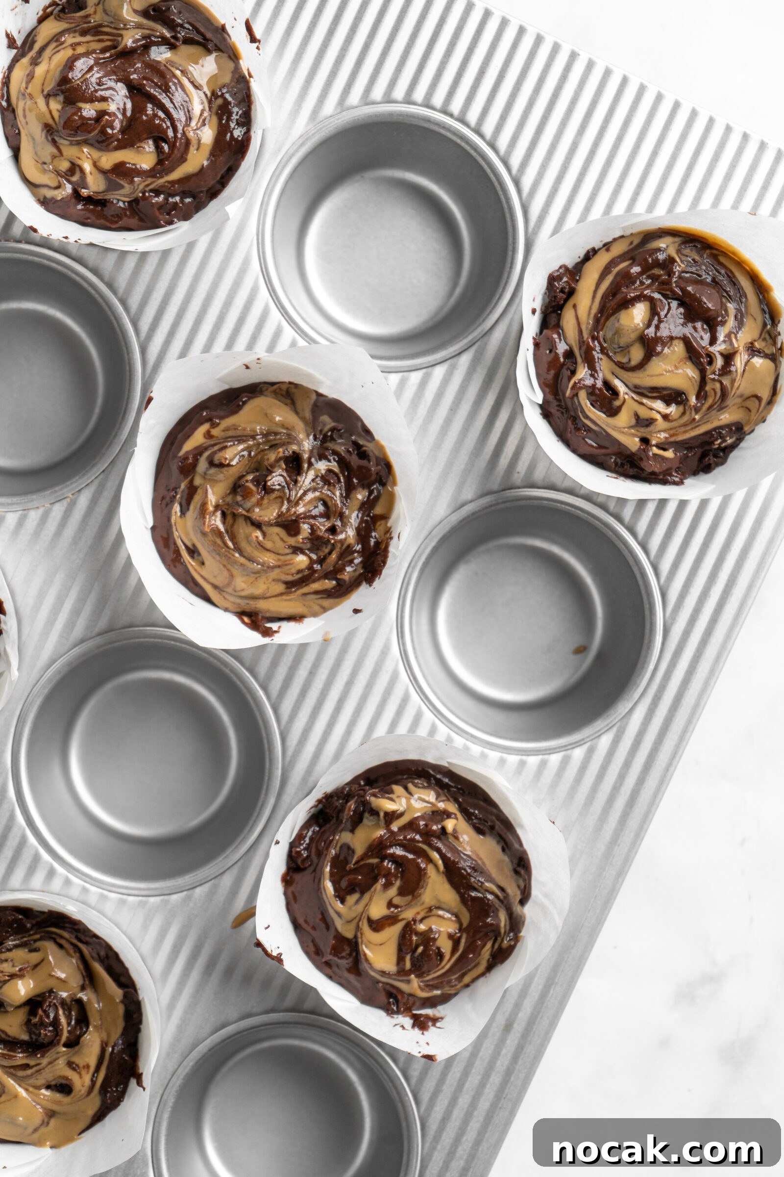 Bakery-Style Double Chocolate Chip Muffins with SunButter Swirl 6 Sunbutter swirled into bakery style double chocolate chip muffin batter.
