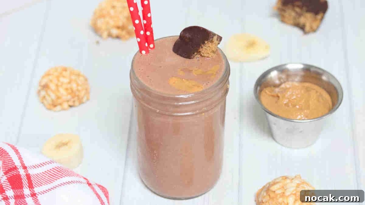 Peanut Butter Cup Protein Shake — 22g Protein Per Serving 14 Chocolate peanut butter cup smoothie in mason jar topped with peanut butter cup and red straws in it.