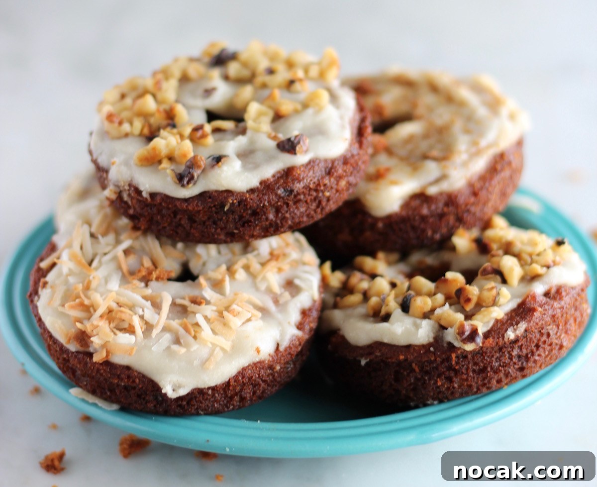 Paleo Carrot Cake Donuts - soft, glazed donuts meet carrot cake in this heavenly combination! | fedandfulfilled.com