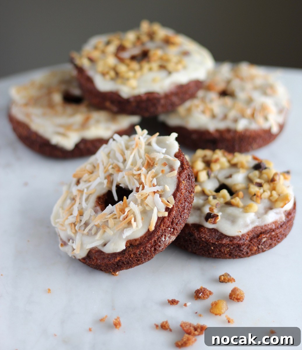 Paleo Carrot Cake Donuts - a delicious combination of baked carrot cake smothered in coconut butter glaze! Your family will LOVE these! | fedandfulfilled.com