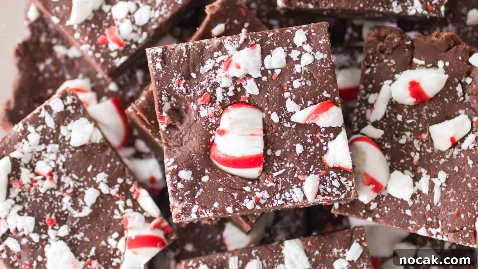30 Christmas Desserts That Steal the Spotlight from Cookies 22 Close-up of chocolate peppermint bark squares topped with crushed candy canes.