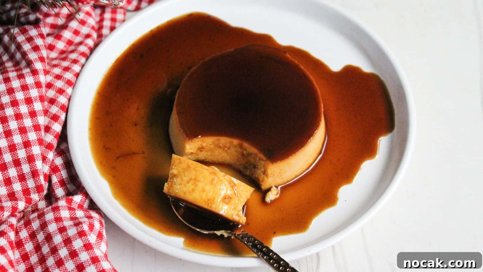 30 Christmas Desserts That Steal the Spotlight from Cookies 9 Leche flan caramel creme brulee on a plate with a spoon.