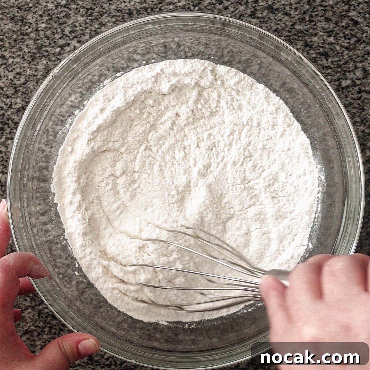 whisking dry ingredients in large glass bowl.