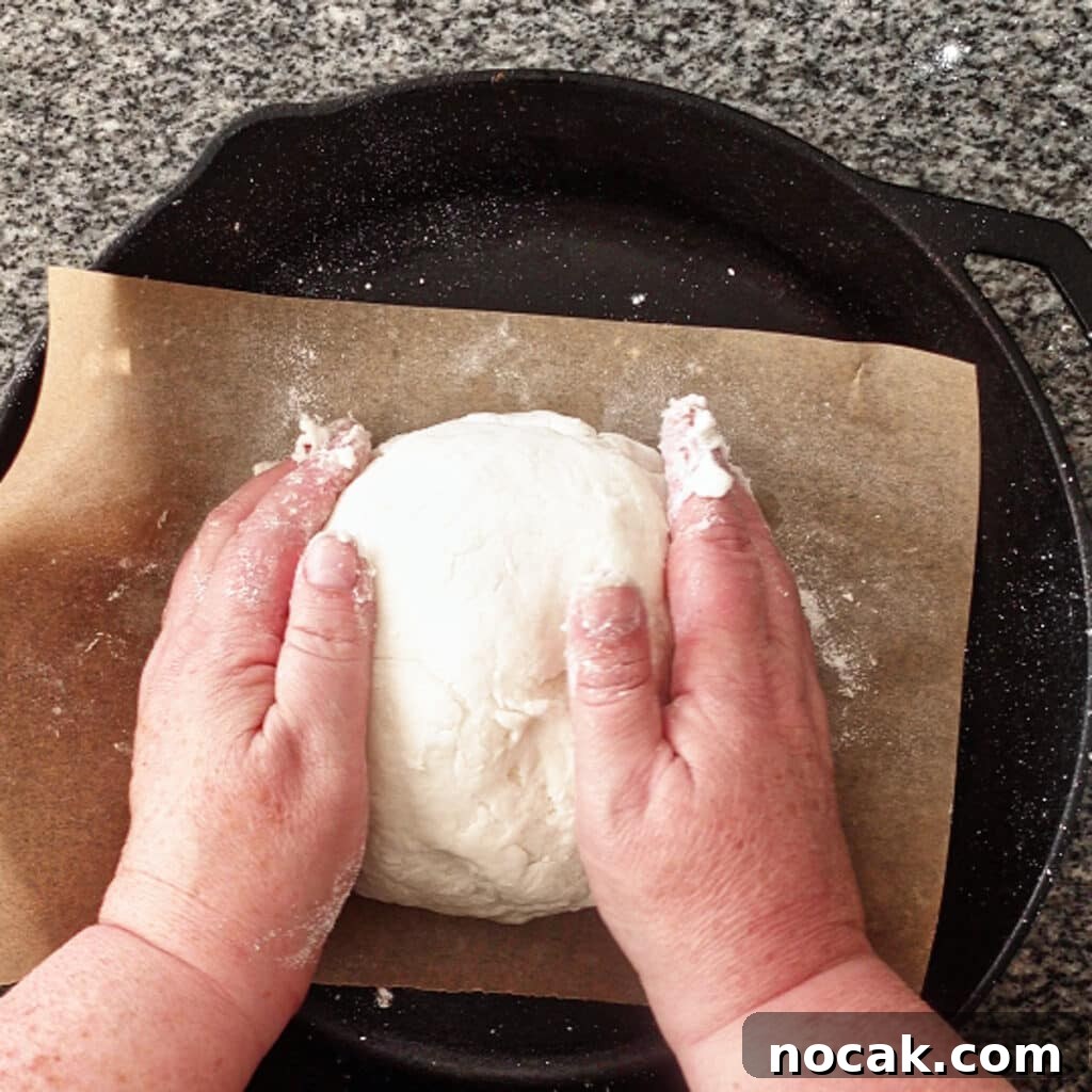 dumping dough onto parchment-lined baking sheet