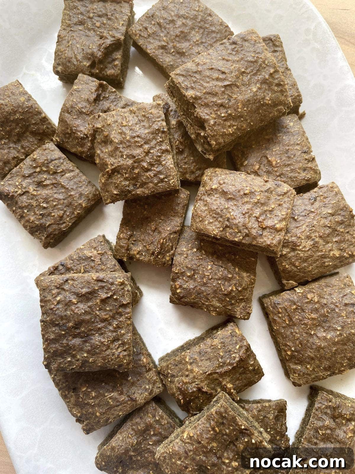 Homemade Liver Brownies: Irresistible Dog Treat Recipe 2 A white plate covered in square liver brownies for dogs.
