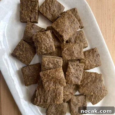 Homemade Liver Brownies: Irresistible Dog Treat Recipe 12 A white plate covered in square liver brownie treats for dogs.
