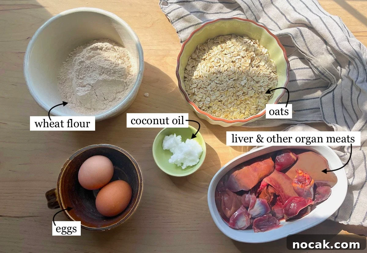 Homemade Liver Brownies: Irresistible Dog Treat Recipe 3 The ingredients in liver brownies, laid out and labeled - oats, wheat flour, organ meats, coconut oil, and eggs.