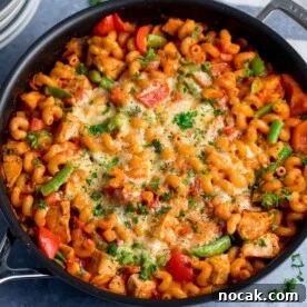 Close up of pan of cheesy chicken pasta