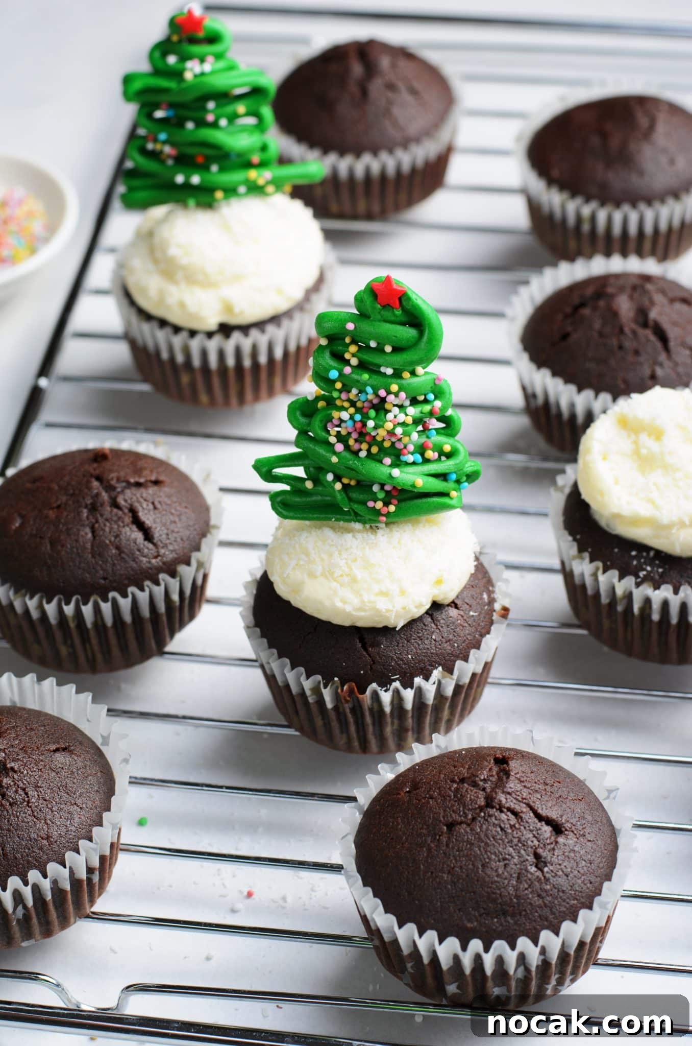 Chocolate Christmas Tree Cupcakes with Vanilla Buttercream Frosting 11 Chocolate cupcakes with vanilla buttercream frosting and topped with a chocolate christmas tree topper.