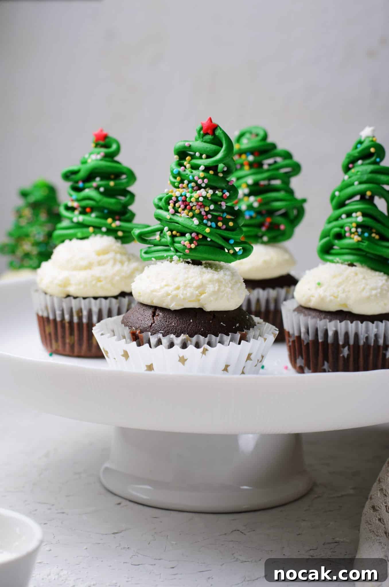 Chocolate Christmas Tree Cupcakes with Vanilla Buttercream Frosting 12 Chocolate cupcakes with vanilla buttercream frosting and topped with a chocolate christmas tree topper.