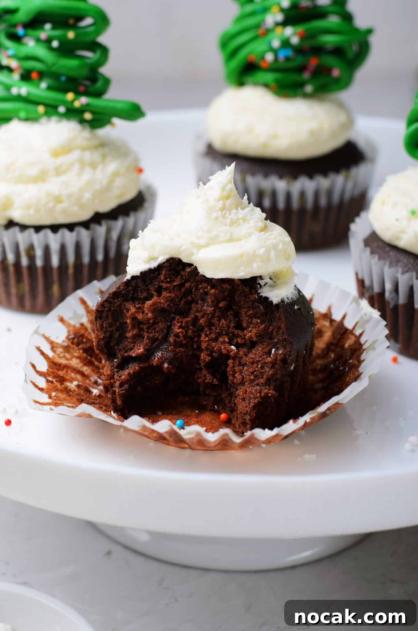 Chocolate Christmas Tree Cupcakes with Vanilla Buttercream Frosting 13 Chocolate cupcakes with vanilla buttercream frosting and topped with a chocolate christmas tree topper.