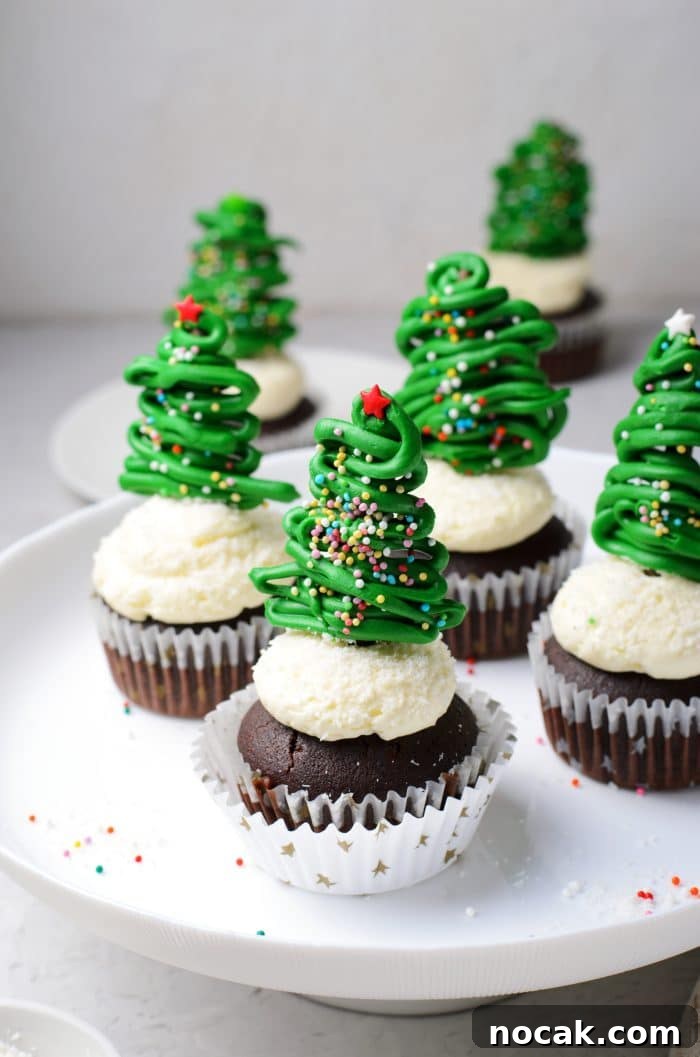 Chocolate Christmas Tree Cupcakes with Vanilla Buttercream Frosting 14 Cake stand filled with four Chocolate cupcakes with vanilla buttercream frosting and topped with a chocolate christmas tree topper.