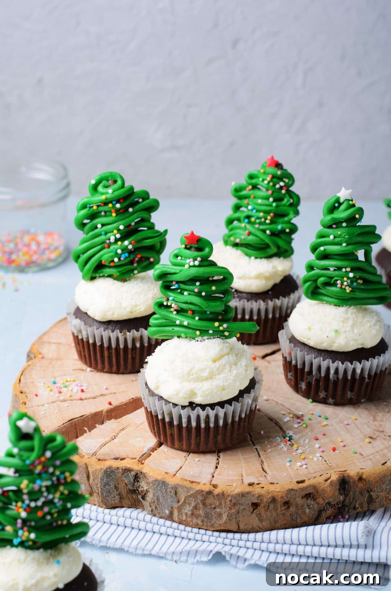 Chocolate Christmas Tree Cupcakes with Vanilla Buttercream Frosting 3 Chocolate cupcakes with vanilla buttercream frosting and topped with a chocolate christmas tree topper.