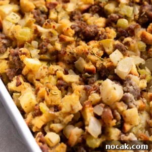 Sausage and Apple Stuffing Recipe for Holiday Feasts 8 Sausage & apple stuffing in a white casserole dish.