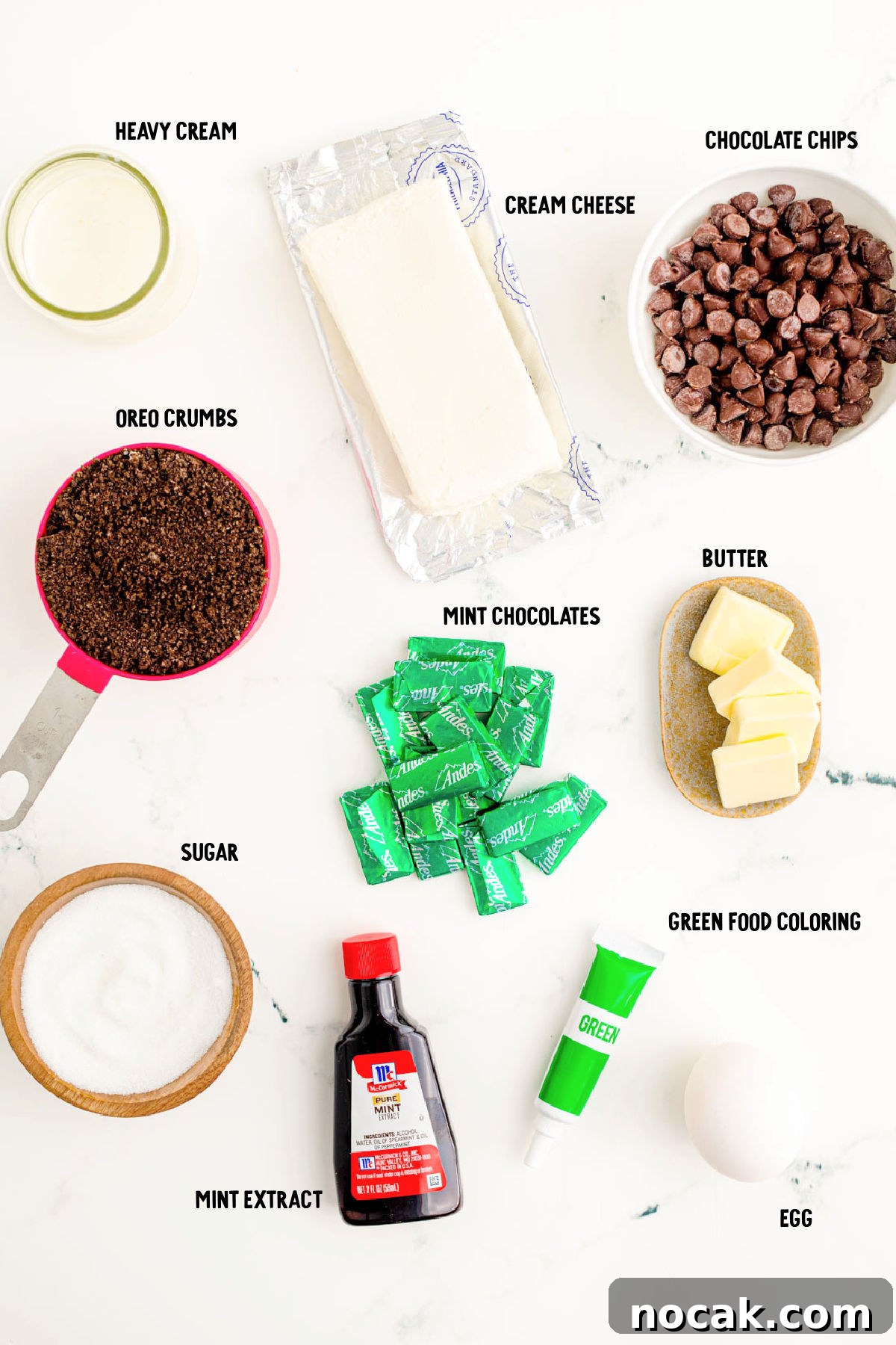 Oreo Chocolate Mint Mini Cheesecakes for St. Patrick’s Day 4 Ingredients to make mint chocolate cheesecakes on a marble surface.