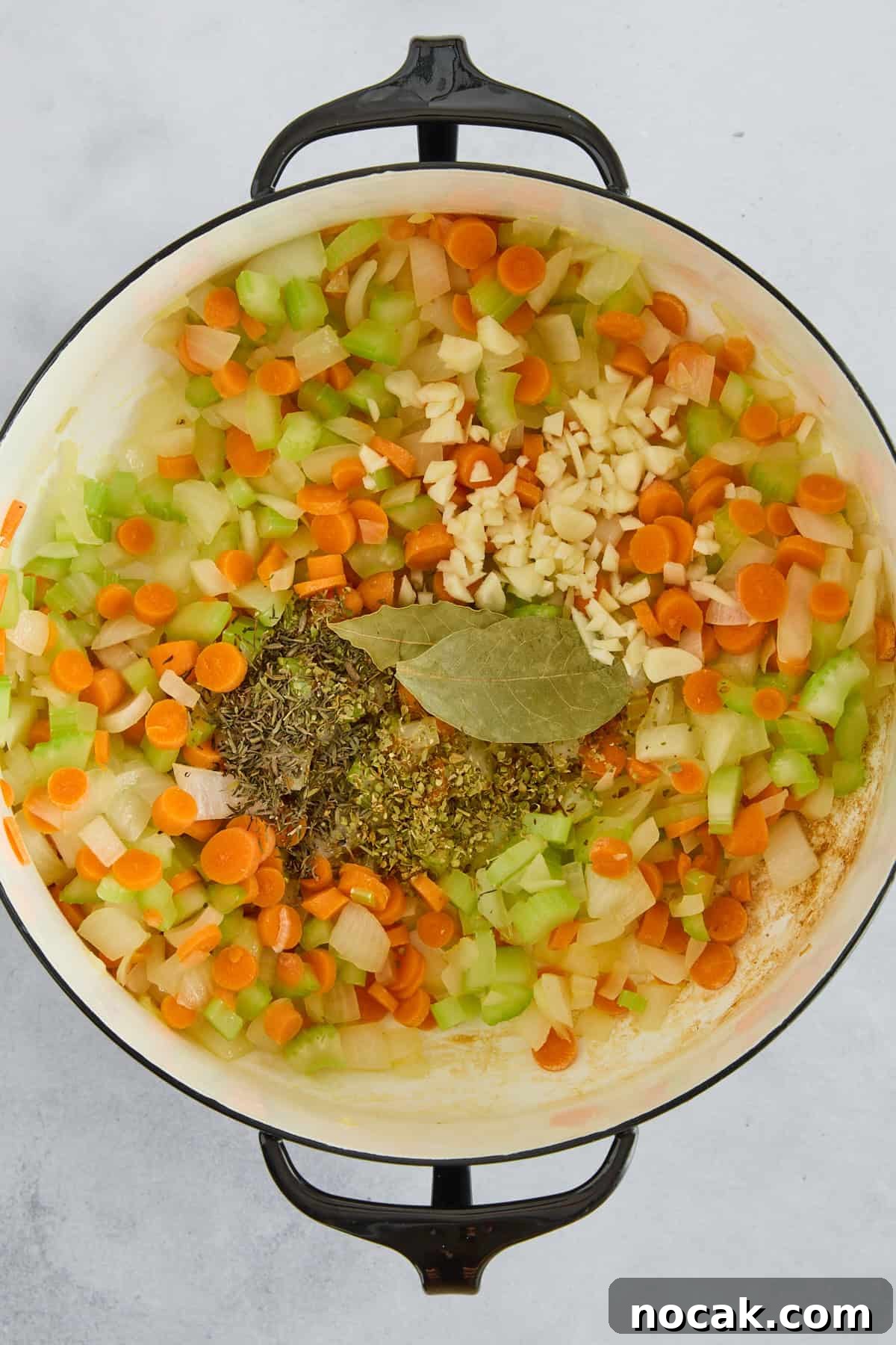Chicken Noodle Soup with Ditalini: Homemade Comfort Recipe 4 Carrots, onions, celery, garlic, bay leaves, and seasonings in a pot.