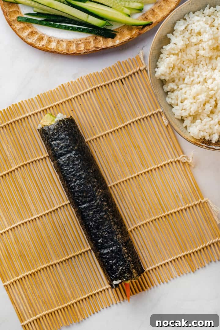 Rolled sushi roll on sushi mat