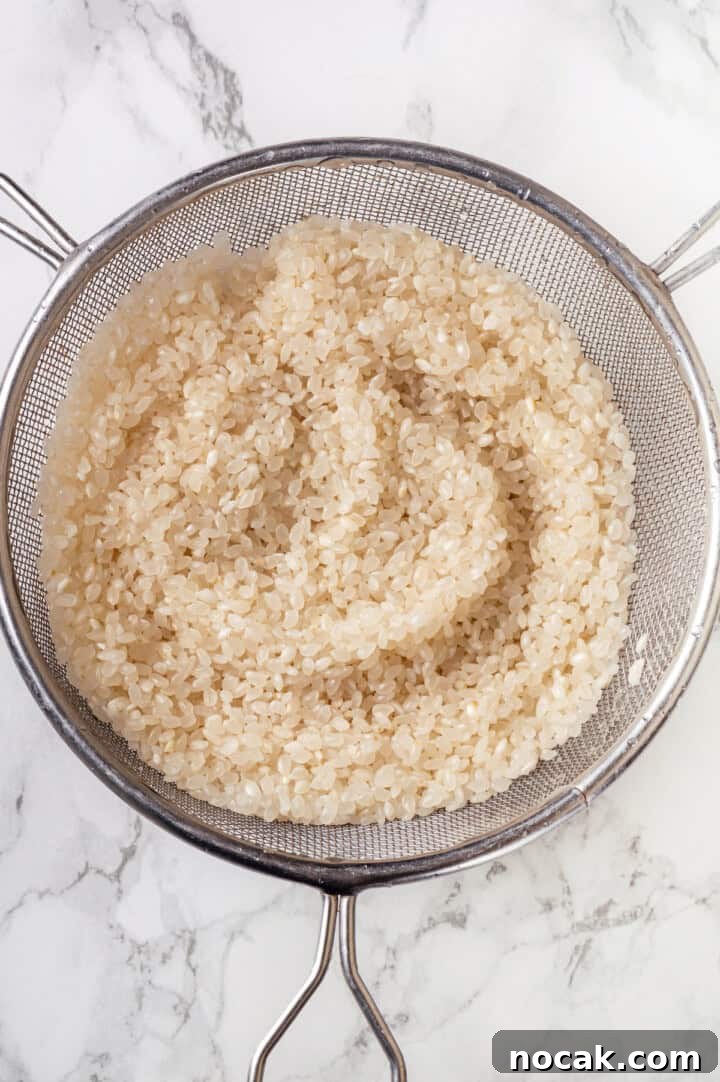 Draining sushi rice in colander