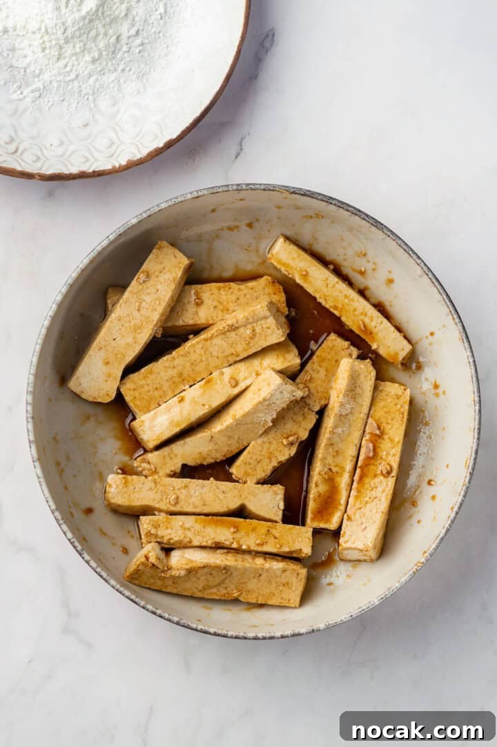 Tofu marinating in soy sauce and sesame oil