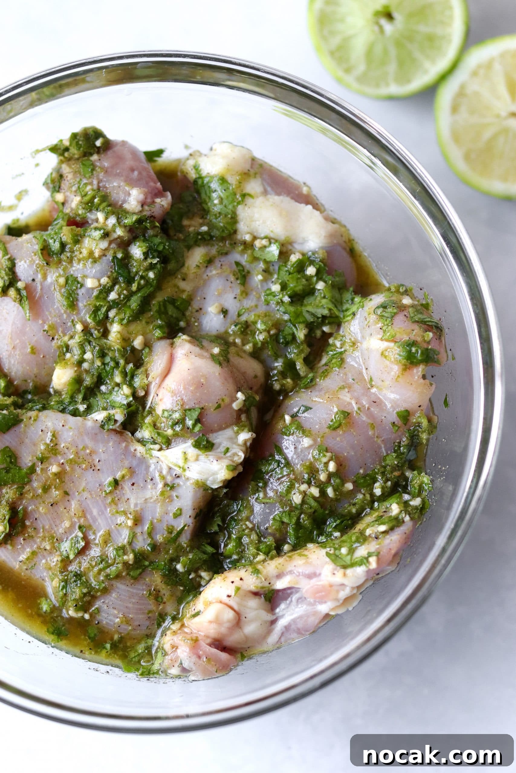 Boneless chicken thighs in a bowl with cilantro lime marinade