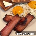 Homemade Hickory-Smoked Bacon Recipe: How to Make Real Bacon 10 Home Cured Hickory Smoked Bacon on white plate with eggs