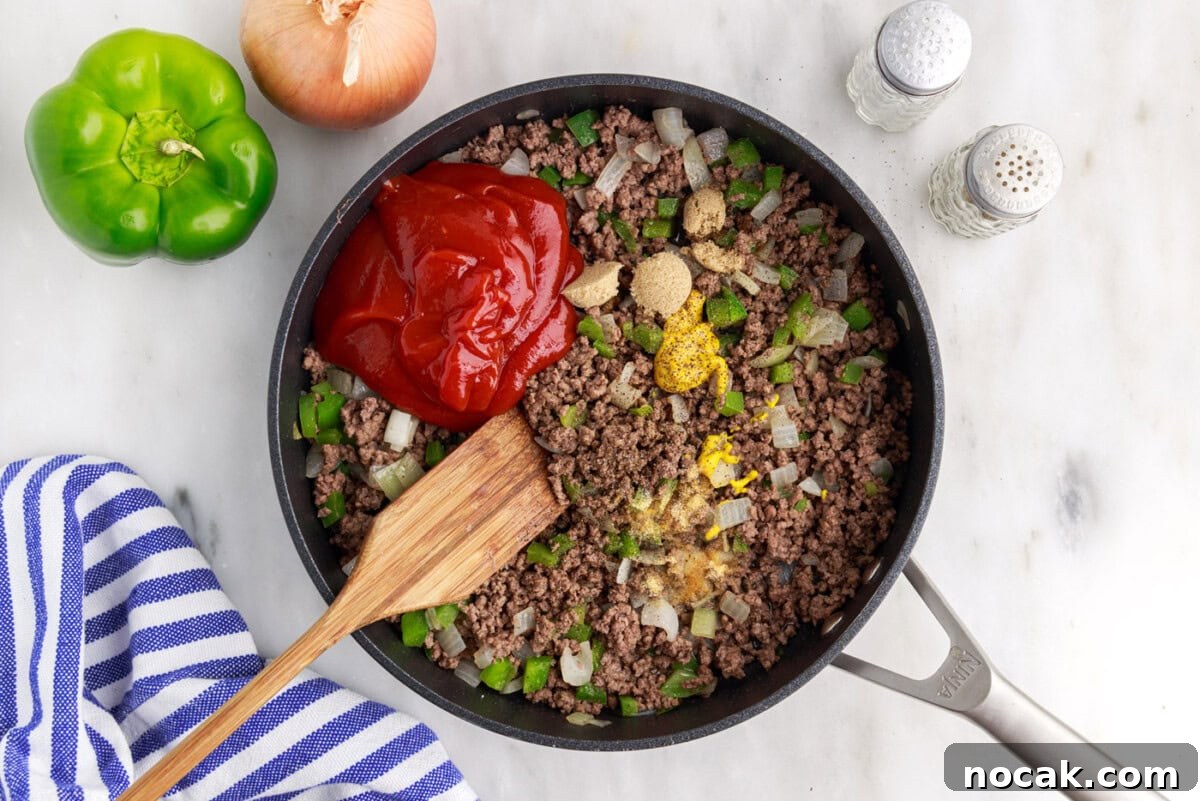 Sloppy Joe Casserole with Cheesy Cornbread Topping 6 sloppy joe ingredients in a skillet