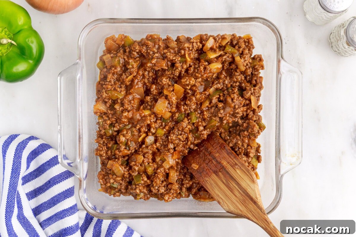 Sloppy Joe Casserole with Cheesy Cornbread Topping 7 sloppy joe meat in a casserole dish
