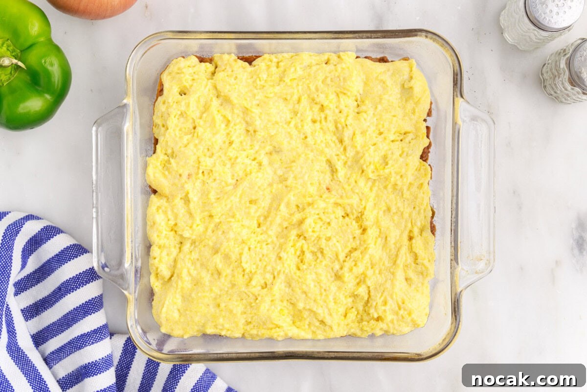 Sloppy Joe Casserole with Cheesy Cornbread Topping 10 sloppy joe cornbread casserole in a baking dish