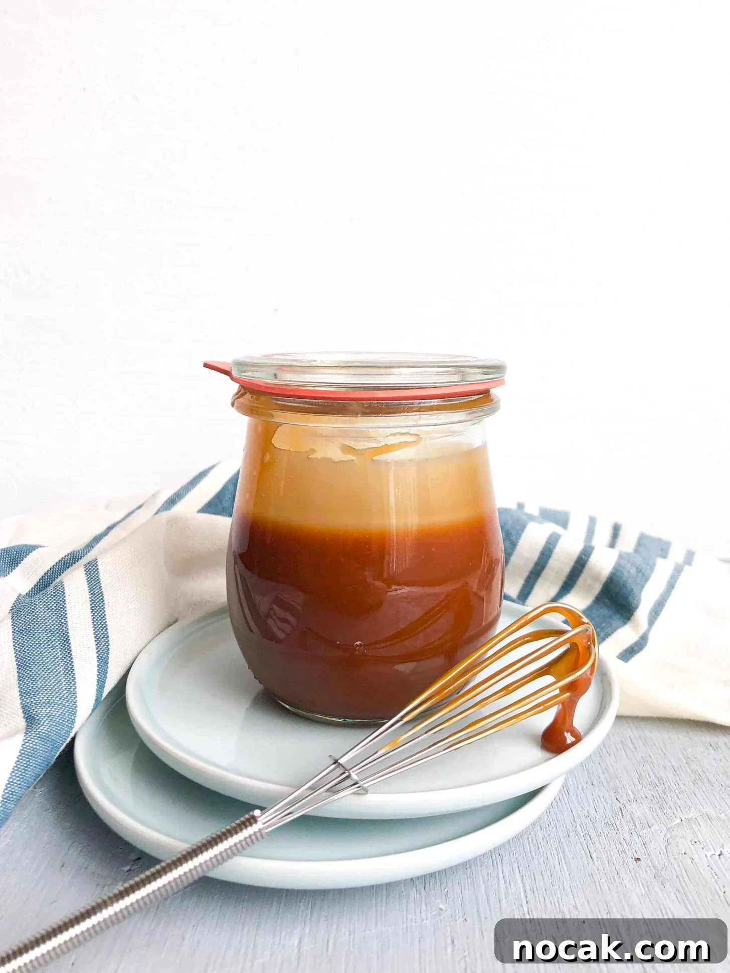 Homemade Caramel Sauce Recipe for Rich, Silky Drizzle 2 A jar of caramel sauce with a whisk