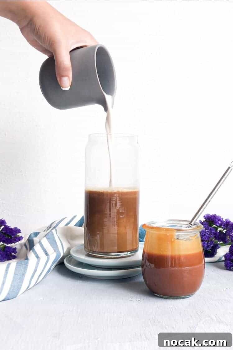 Homemade Caramel Sauce Recipe for Rich, Silky Drizzle 6 Cream pouring into a caramel coffee