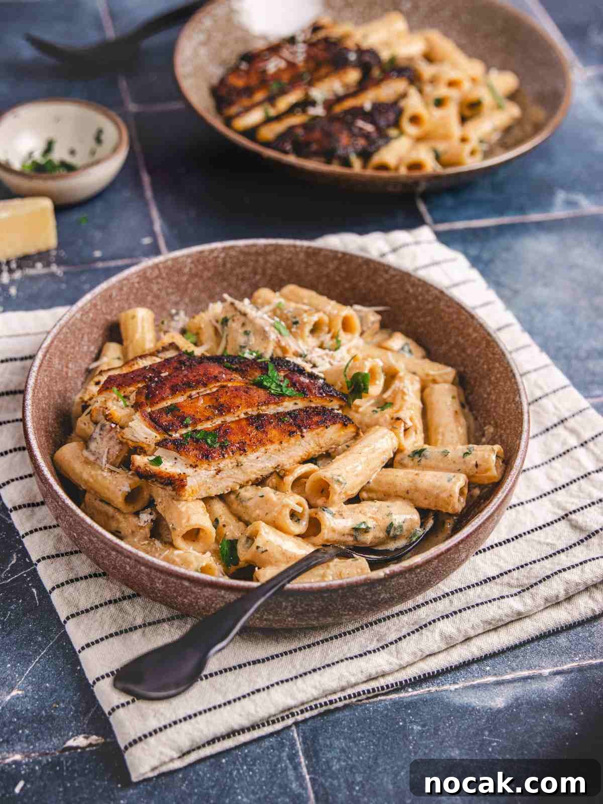 Blackened Chicken Alfredo Pasta Recipe: Creamy Cajun-Style Dinner 8 Linguine alfredo with chicken in a bowl with spoon.