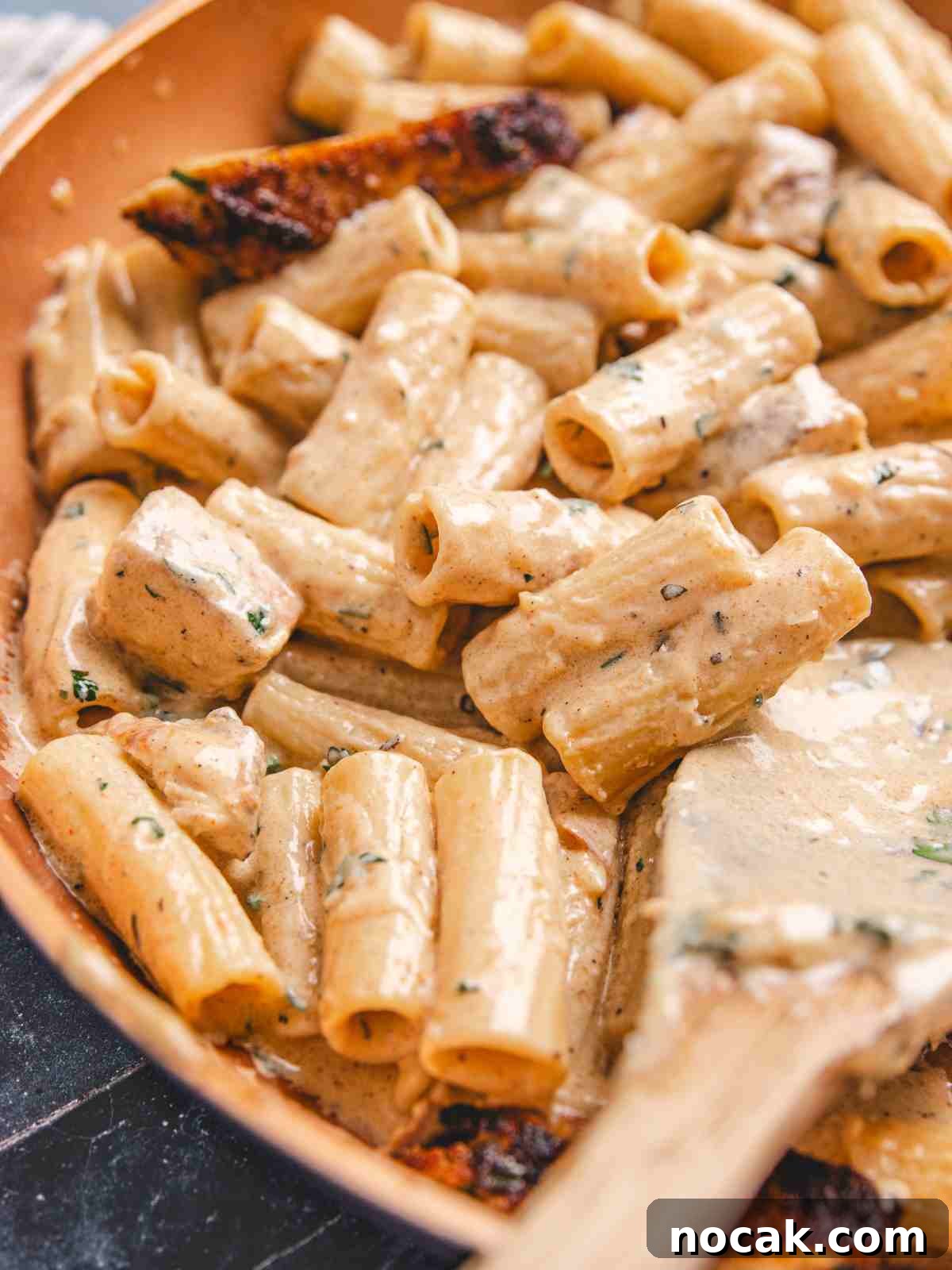 Blackened Chicken Alfredo Pasta Recipe: Creamy Cajun-Style Dinner 9 creamy alfredo in a pan.