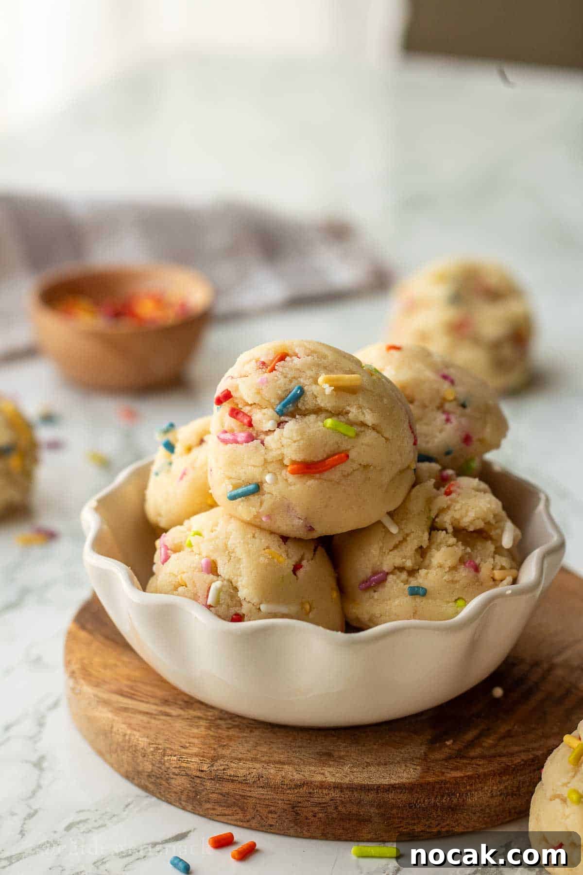 Edible Sugar Cookie Dough Recipe — Egg-Free & Safe to Eat 9 Scoops of edible sugar cookie dough in bowl ,