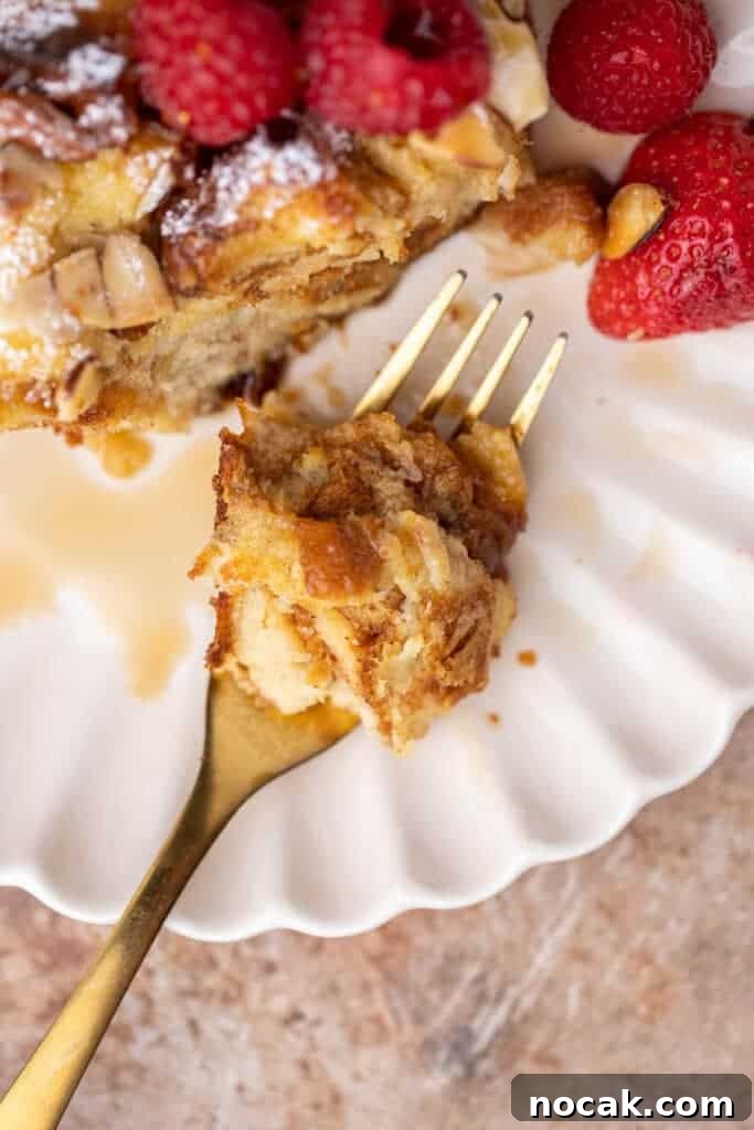 Brioche French Toast Casserole Baked in the Oven 12 Fork with a bite of brioche French toast in it