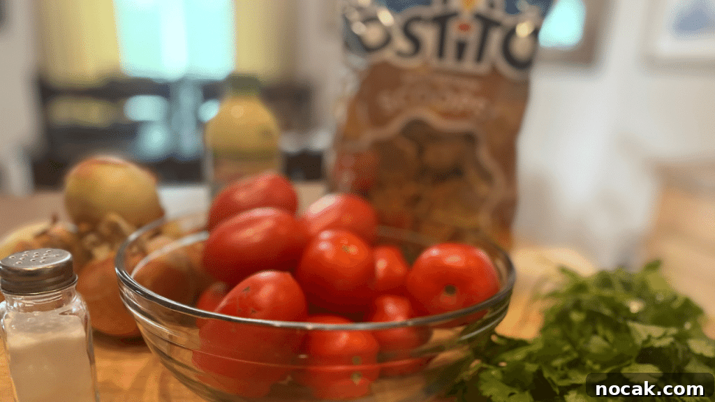 Fresh Homemade Pico de Gallo Recipe for Mild Salsa 3 fresh salsa ingredients on cutting board, tomatoes, onions, cilantro, chips