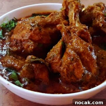 hyderabadi chicken masala served in a white bowl.