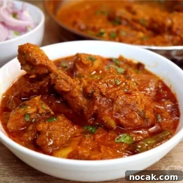 kashmiri chicken served in a white bowl.